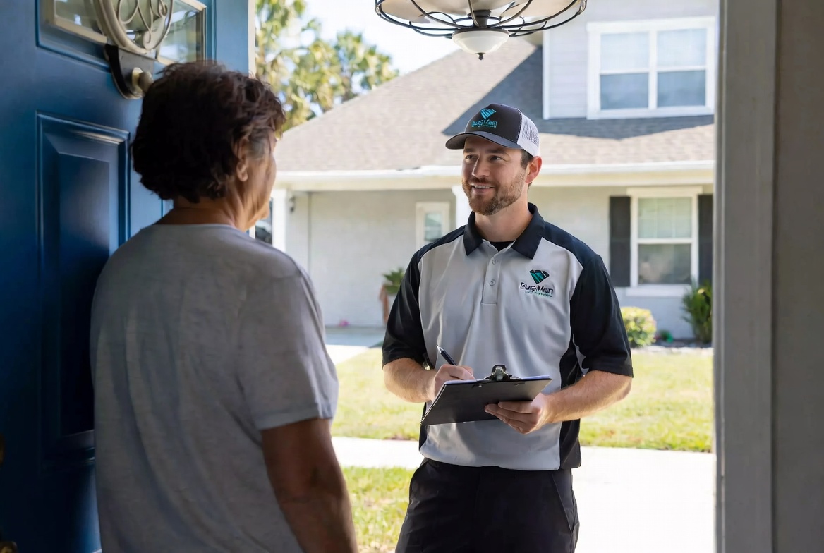 Bug-Man Pest Control service truck at a residential gate in a Jacksonville Florida neighborhood
